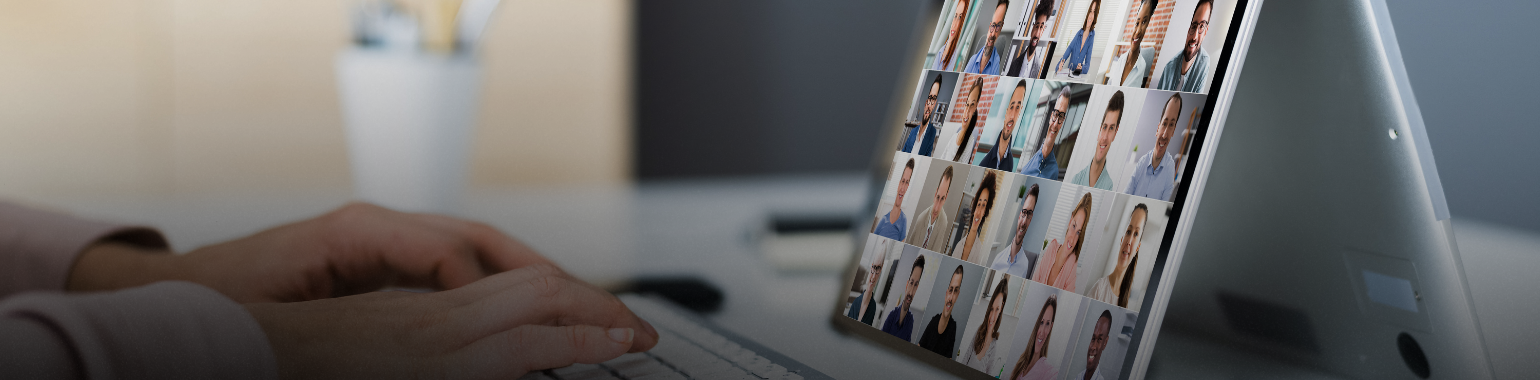 Photo of a person watching a webinar on a laptop.